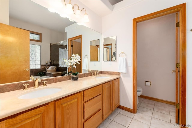 15851 Deer Ridge Dr, Morrison, CO 80465 - bathroom with tile patterned floors, toilet, double vanity, and a shower with door