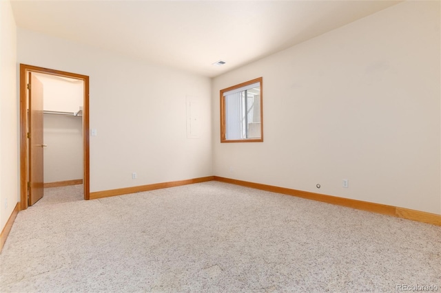 15851 Deer Ridge Dr, Morrison, CO 80465 - unfurnished bedroom featuring baseboards, a spacious closet, and light colored carpet