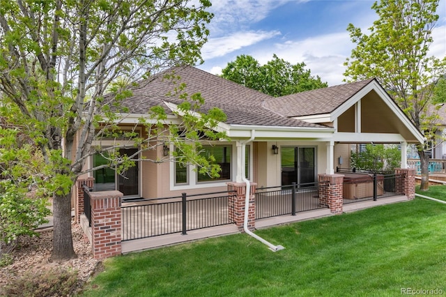 15851 Deer Ridge Dr, Morrison, CO 80465 - rear view of house featuring a shingled roof, a patio area, a lawn, and a hot tub
