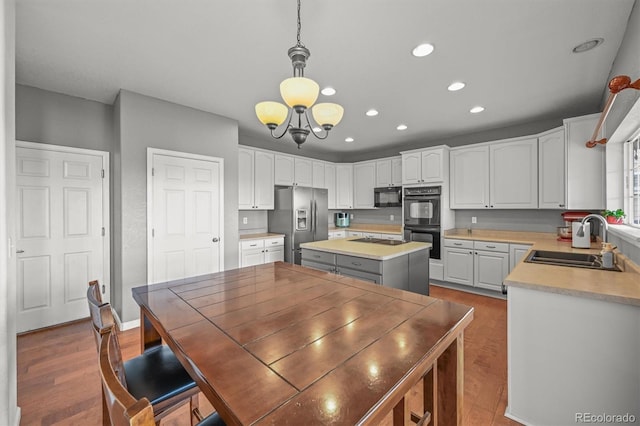 1120 N Calhan Ave, Castle Rock, CO 80104 - kitchen featuring black appliances, a sink, recessed lighting, a center island, and white cabinetry
