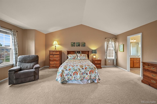 1120 N Calhan Ave, Castle Rock, CO 80104 - bedroom with light colored carpet, lofted ceiling, baseboards, and ensuite bathroom