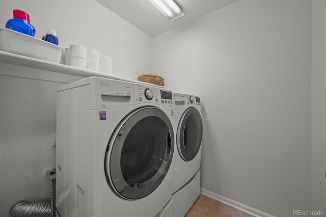 1120 N Calhan Ave, Castle Rock, CO 80104 - laundry area with washing machine and clothes dryer, light tile patterned flooring, and baseboards