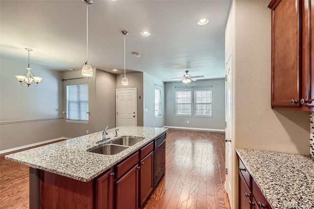 8883 White Prairie Vw, Colorado Springs, CO 80924 - kitchen featuring open floor plan, light wood-style floors, an island with sink, pendant lighting, and recessed lighting