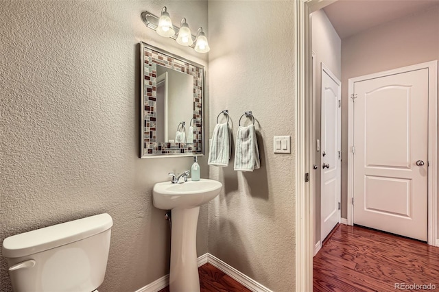 8883 White Prairie Vw, Colorado Springs, CO 80924 - half bathroom featuring wood finished floors and a textured wall