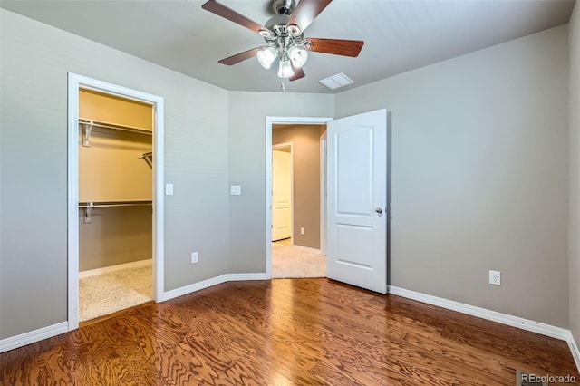 8883 White Prairie Vw, Colorado Springs, CO 80924 - unfurnished bedroom with wood finished floors, a spacious closet, a closet, and a ceiling fan