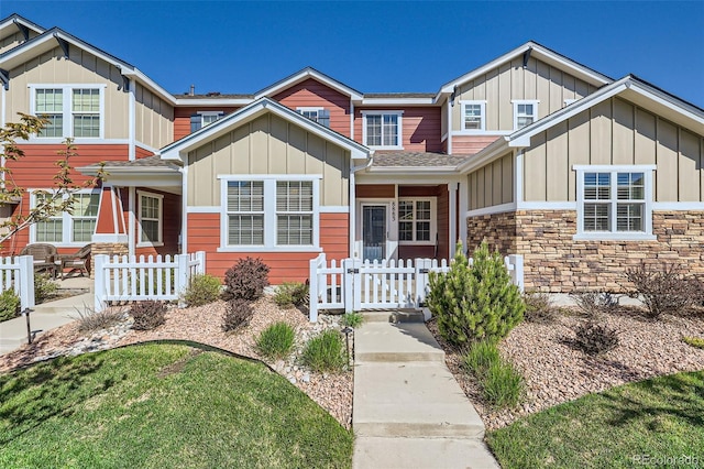 8883 White Prairie Vw, Colorado Springs, CO 80924 - view of front of home featuring board and batten siding, stone siding, and roof with shingles