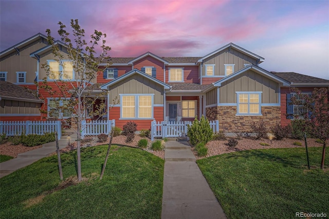 8883 White Prairie Vw, Colorado Springs, CO 80924 - view of front facade with board and batten siding, a shingled roof, and stone siding