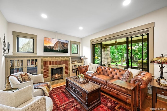 1414 S Vine St, Denver, CO 80210 - living room with wood finished floors, recessed lighting, and a brick fireplace