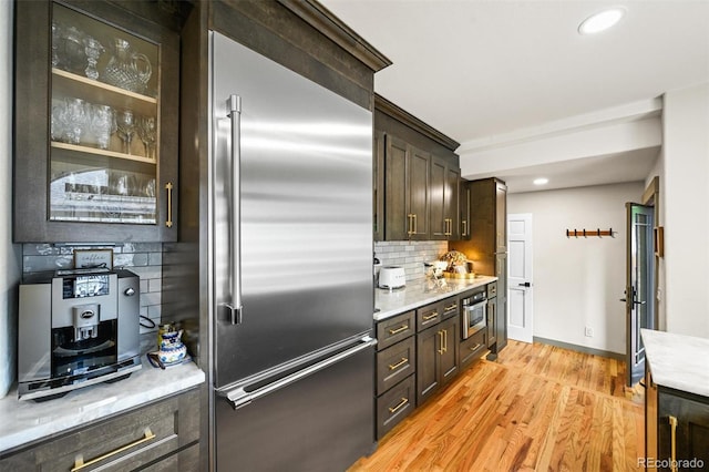 1414 S Vine St, Denver, CO 80210 - kitchen featuring stainless steel appliances, light wood-type flooring, backsplash, dark brown cabinets, and recessed lighting