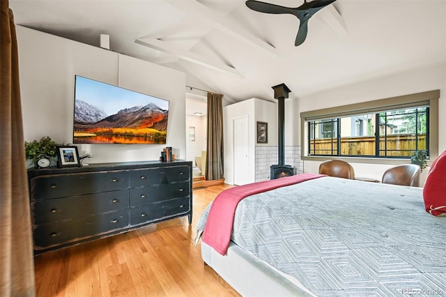 1414 S Vine St, Denver, CO 80210 - bedroom featuring a wood stove, lofted ceiling, light wood-style floors, and ceiling fan