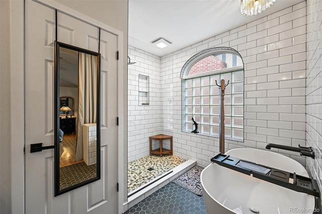 1414 S Vine St, Denver, CO 80210 - bathroom featuring tile walls, a freestanding bath, and a tile shower