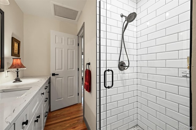 1414 S Vine St, Denver, CO 80210 - bathroom featuring a stall shower, wood finished floors, and vanity