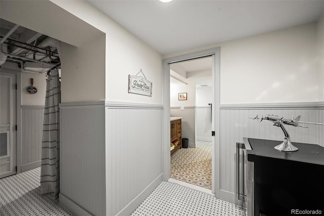 1414 S Vine St, Denver, CO 80210 - bathroom featuring a wainscoted wall and tile patterned floors
