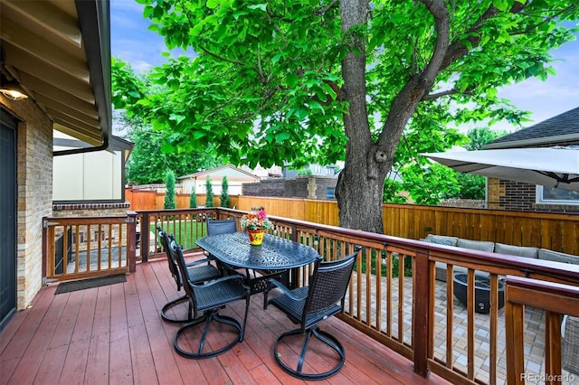 1414 S Vine St, Denver, CO 80210 - wooden deck with outdoor dining space, a fenced backyard, and outdoor lounge area