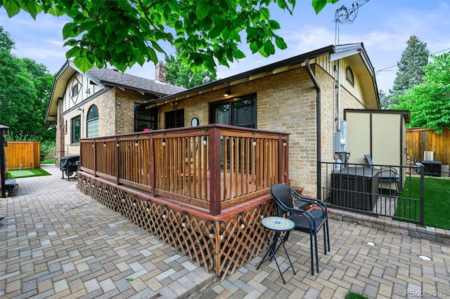 1414 S Vine St, Denver, CO 80210 - back of house featuring brick siding, a deck, a chimney, and a patio area