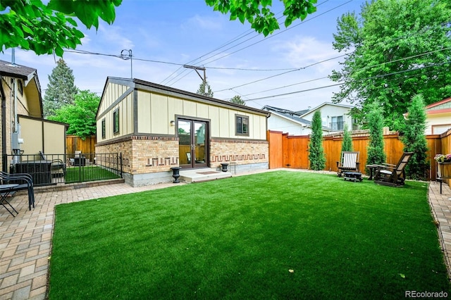 1414 S Vine St, Denver, CO 80210 - rear view of property with brick siding, a fenced backyard, and board and batten siding