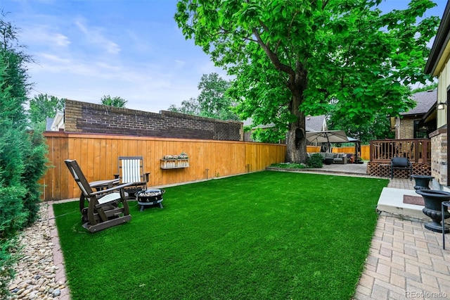 1414 S Vine St, Denver, CO 80210 - fenced backyard featuring a fire pit and a patio area