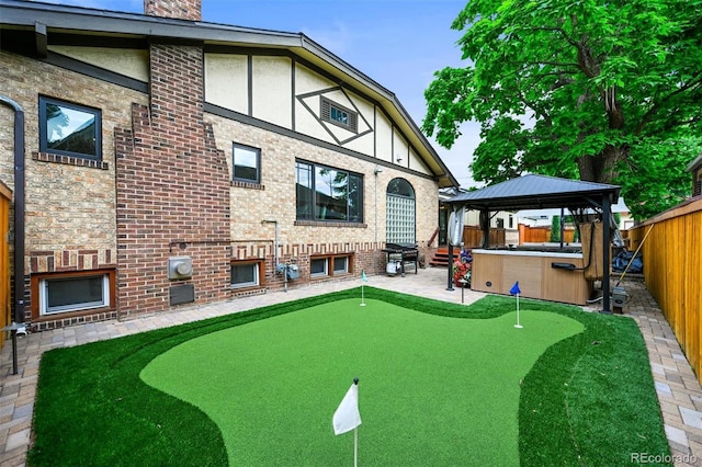 1414 S Vine St, Denver, CO 80210 - back of property featuring a putting green, a gazebo, a patio, a fenced backyard, and a chimney