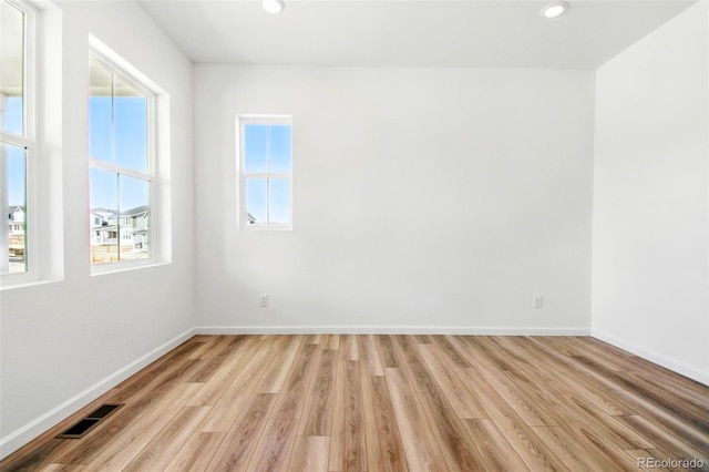 unfurnished room with recessed lighting, visible vents, baseboards, and light wood-style flooring