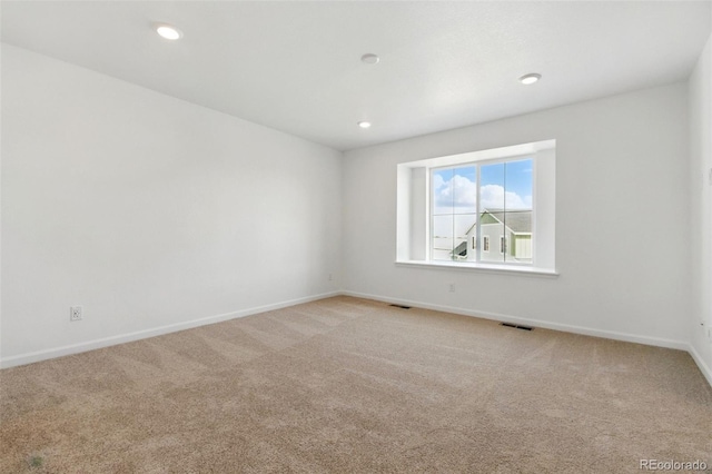 unfurnished room featuring recessed lighting, visible vents, light colored carpet, and baseboards