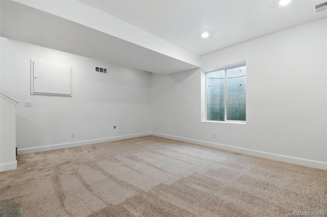 spare room with light carpet, visible vents, and recessed lighting