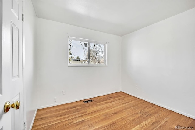 empty room with light hardwood / wood-style flooring