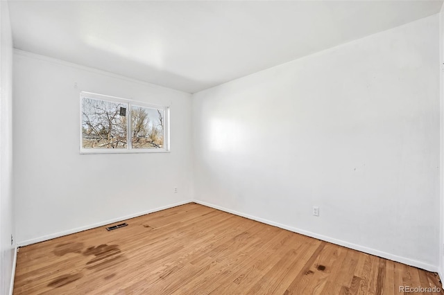 spare room featuring wood-type flooring