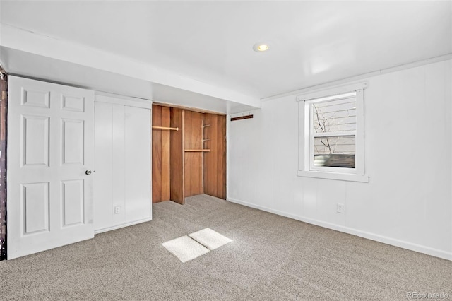 unfurnished bedroom featuring carpet floors and a closet