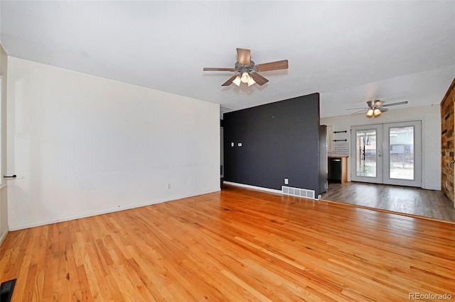 1822 N Circle Dr, Colorado Springs, CO 80909 - unfurnished living room with ceiling fan, hardwood / wood-style floors, baseboards, and french doors