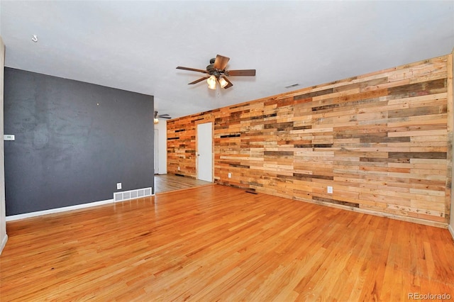 1822 N Circle Dr, Colorado Springs, CO 80909 - unfurnished room featuring ceiling fan, wood finished floors, wood walls, and baseboards