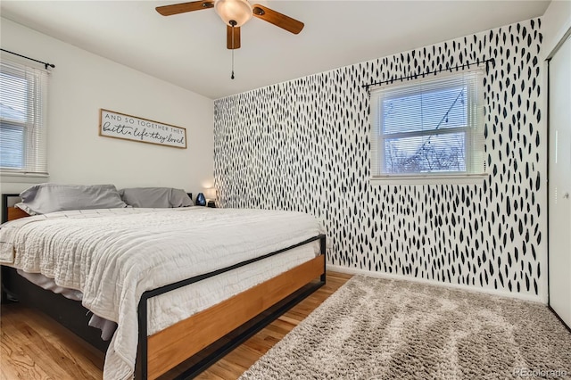1822 N Circle Dr, Colorado Springs, CO 80909 - bedroom featuring wallpapered walls, wood finished floors, a ceiling fan, and baseboards