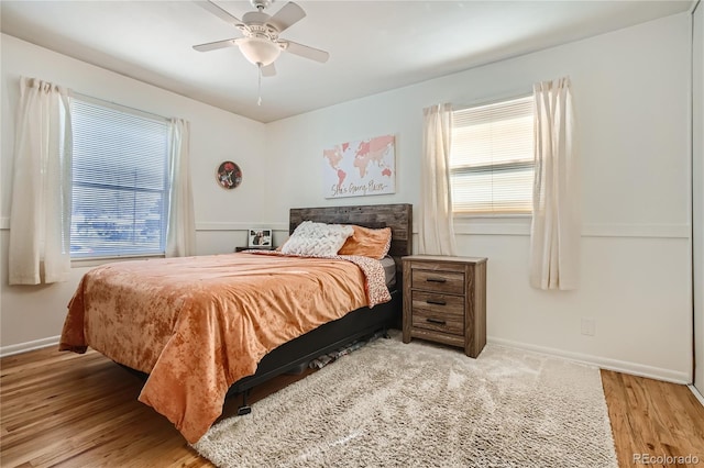 1822 N Circle Dr, Colorado Springs, CO 80909 - bedroom featuring multiple windows, wood finished floors, baseboards, and a ceiling fan