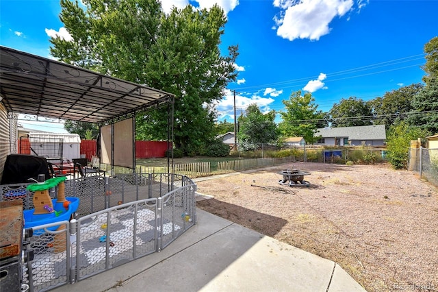 1822 N Circle Dr, Colorado Springs, CO 80909 - view of patio featuring an outdoor fire pit, a fenced backyard, a storage unit, and an outdoor structure