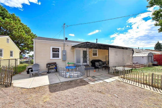 1822 N Circle Dr, Colorado Springs, CO 80909 - back of house with a patio area, a storage unit, a fenced backyard, an outbuilding, and a pergola