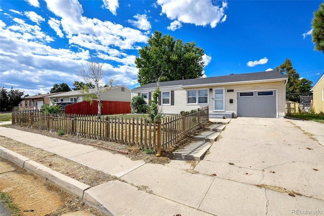 1822 N Circle Dr, Colorado Springs, CO 80909 - single story home with a garage, concrete driveway, and a fenced front yard