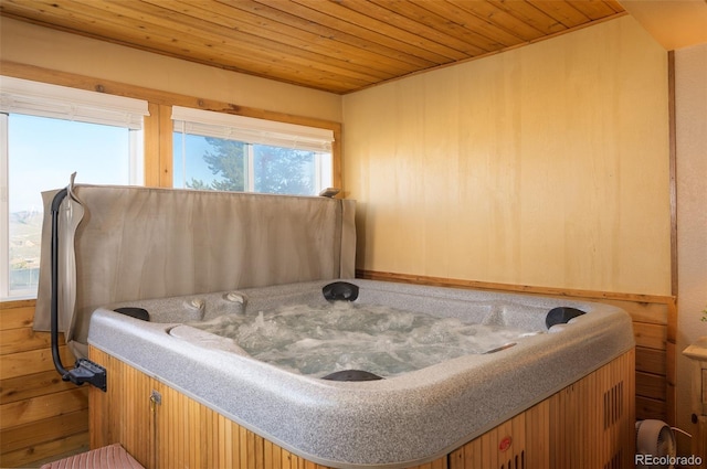 bedroom with multiple windows and wooden ceiling