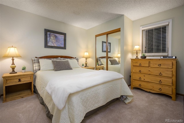 carpeted bedroom featuring a closet and a textured ceiling