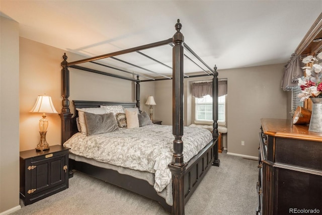 bedroom featuring baseboards and light carpet