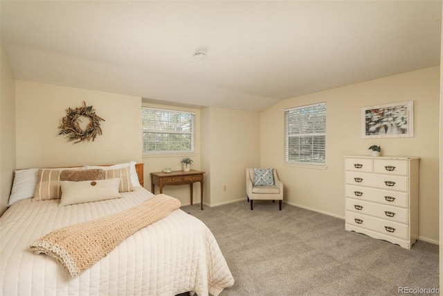 bedroom with baseboards, vaulted ceiling, and light carpet