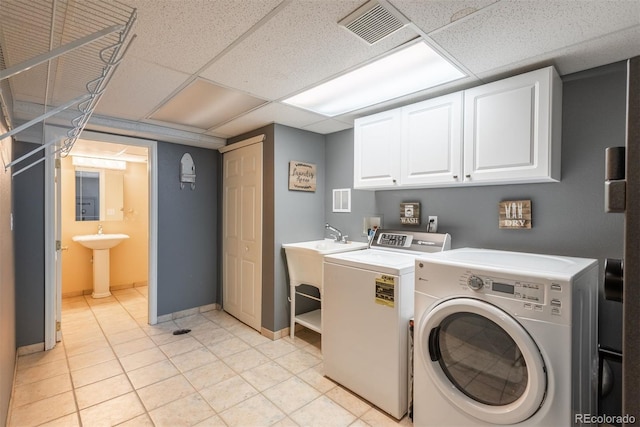 laundry room with cabinet space, a sink, separate washer and dryer, baseboards, and visible vents