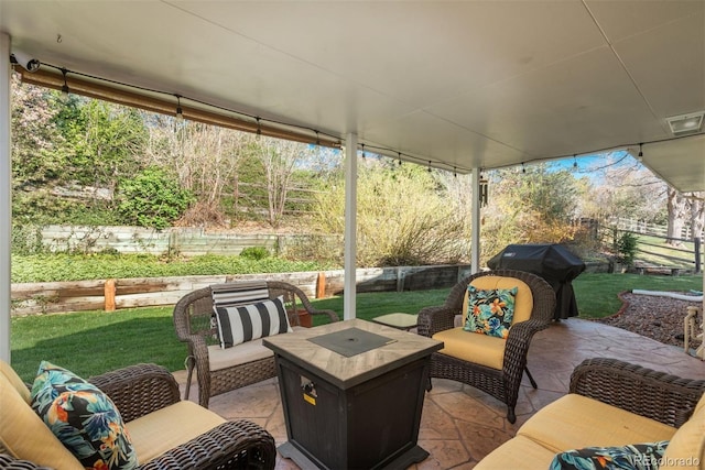 view of patio featuring a fenced backyard, an outdoor living space with a fire pit, and visible vents