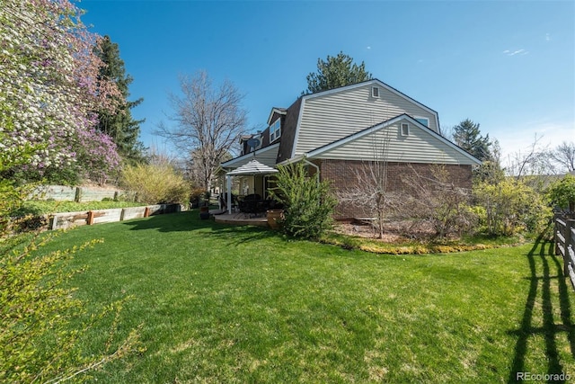 view of side of home featuring a yard