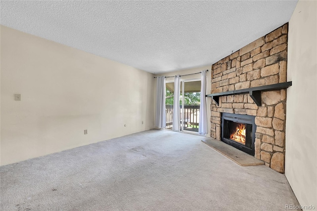 1830 S Pitkin Cir Unit B, Aurora, CO 80017 - unfurnished living room featuring a fireplace, carpet, and a textured ceiling