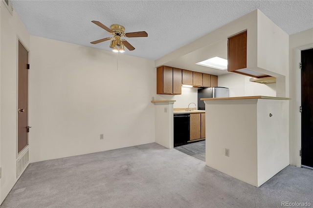 1830 S Pitkin Cir Unit B, Aurora, CO 80017 - kitchen with black dishwasher, light colored carpet, ceiling fan, a textured ceiling, and light countertops
