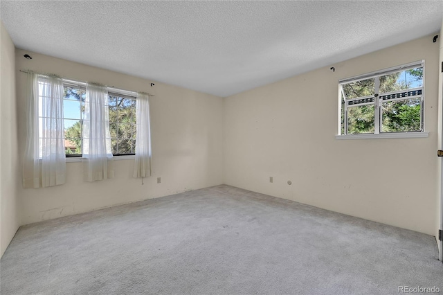 1830 S Pitkin Cir Unit B, Aurora, CO 80017 - carpeted empty room featuring healthy amount of natural light and a textured ceiling