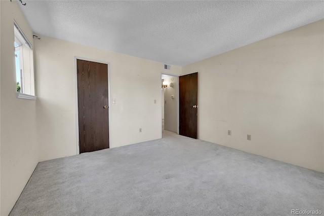 1830 S Pitkin Cir Unit B, Aurora, CO 80017 - empty room with carpet and a textured ceiling