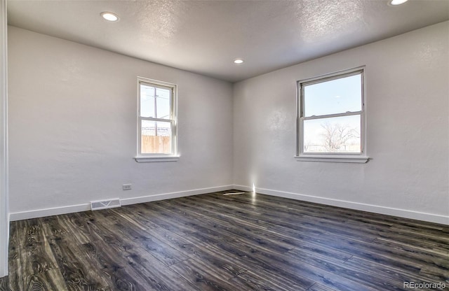 spare room with dark hardwood / wood-style floors