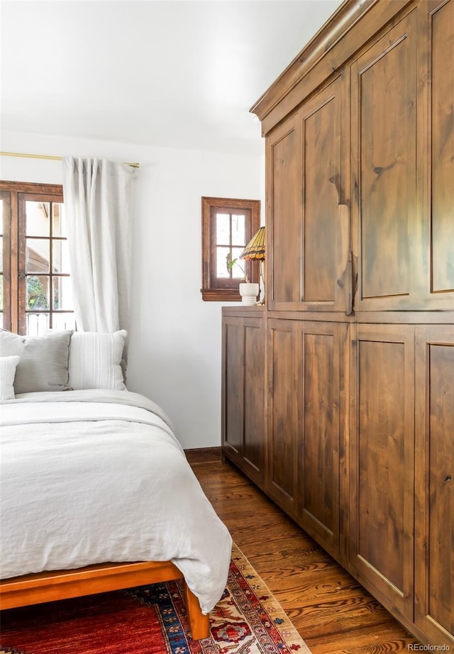 bedroom with dark wood finished floors