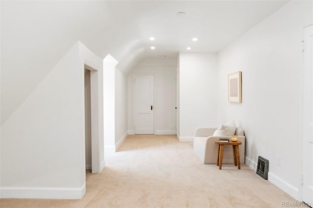 interior space featuring light colored carpet, visible vents, recessed lighting, baseboards, and vaulted ceiling