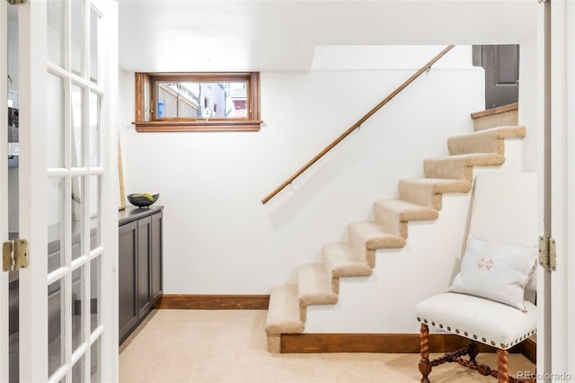 stairway featuring carpet flooring